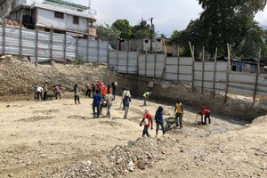 Manual fine-tuning of excavated site.