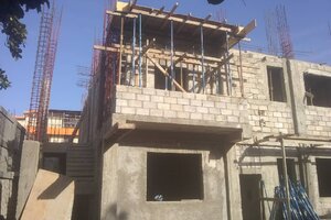 Front left corner of the building.  You can see the alternate stairway to the second floor.  The room shown on the second floor is the conference room, having a small balcony.  The first floor room is the chapel..
