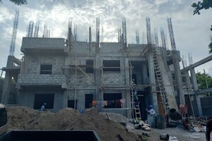 nice clear shot of front of building with third floor walls half up.